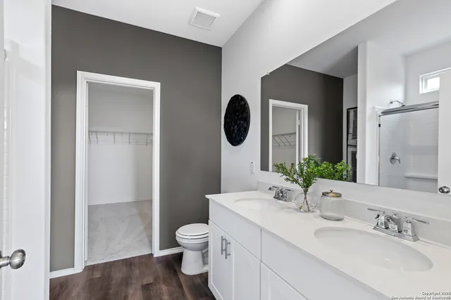 a bathroom with a toilet sink and shower