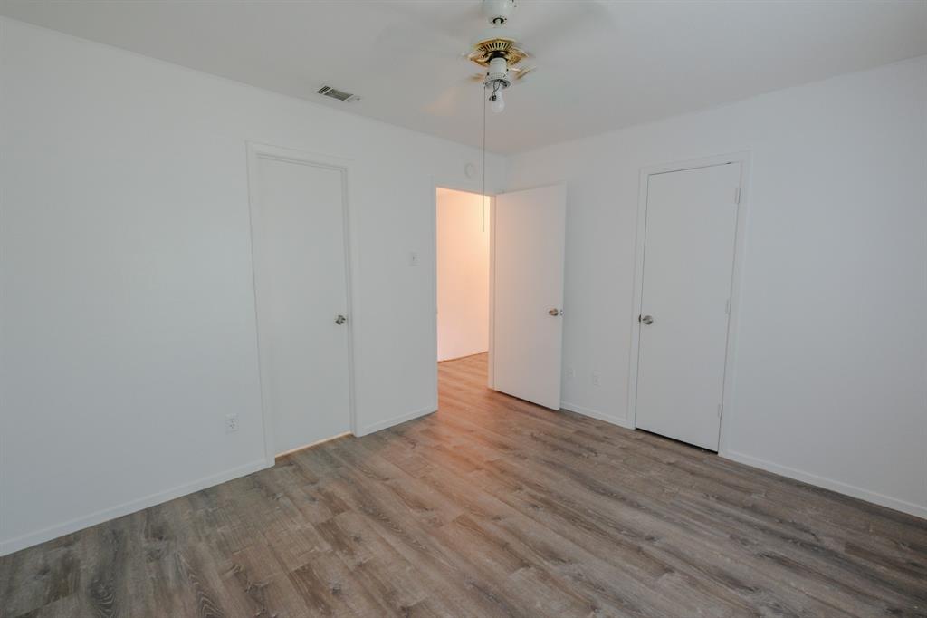 1032 McKinley Street, Unit A Benbrook, TX 76126 - Photo 11 of 14 a view of an empty room with wooden floor