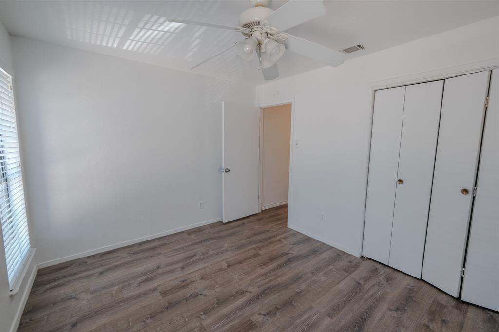 1032 McKinley Street, Unit A Benbrook, TX 76126 - Photo 13 of 14 a view of an empty room with wooden floor