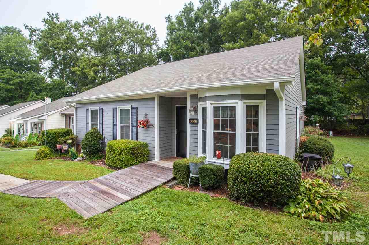 6808 Fairpoint Court Raleigh, NC 27613 - Photo 3 of 16 a view of a house with a yard and plants