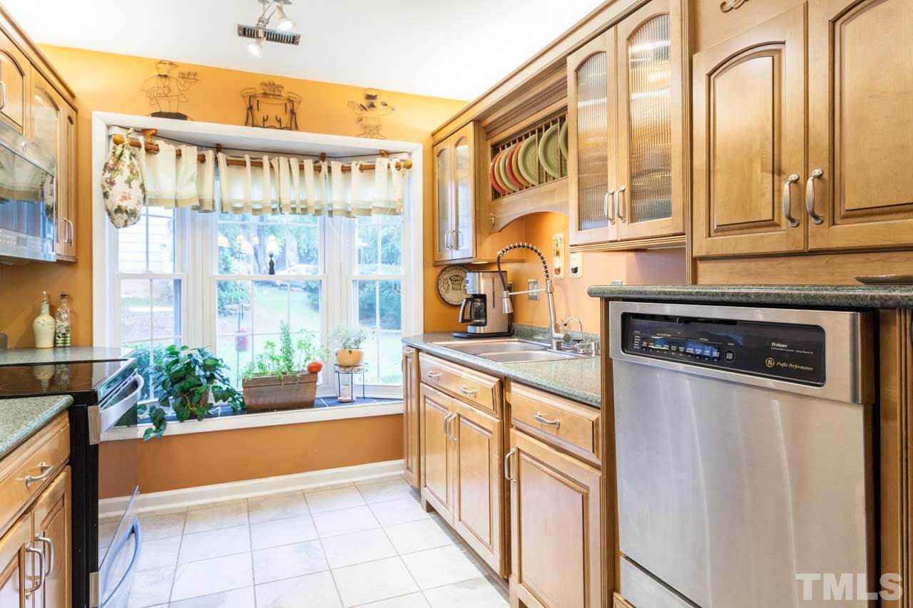 6808 Fairpoint Court Raleigh, NC 27613 - Photo 8 of 16 a kitchen with stainless steel appliances granite countertop a stove and a large window