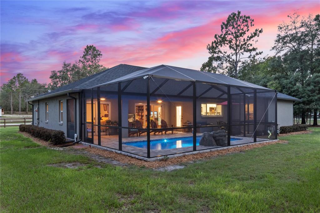 12929 Southwest 89th Street Dunnellon, FL 34432 - Photo 46 of 76 a backyard of a house with lots of green space