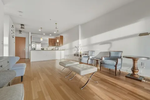 a living room with furniture and kitchen view