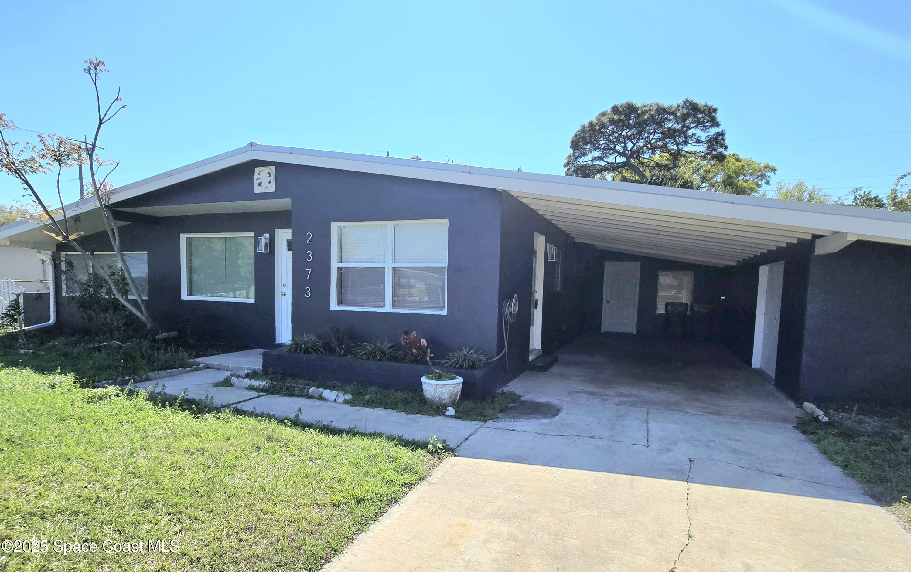 2373 Allan Adale Road Melbourne, FL 32935 - Photo 1 of 19 a front view of a house with a yard