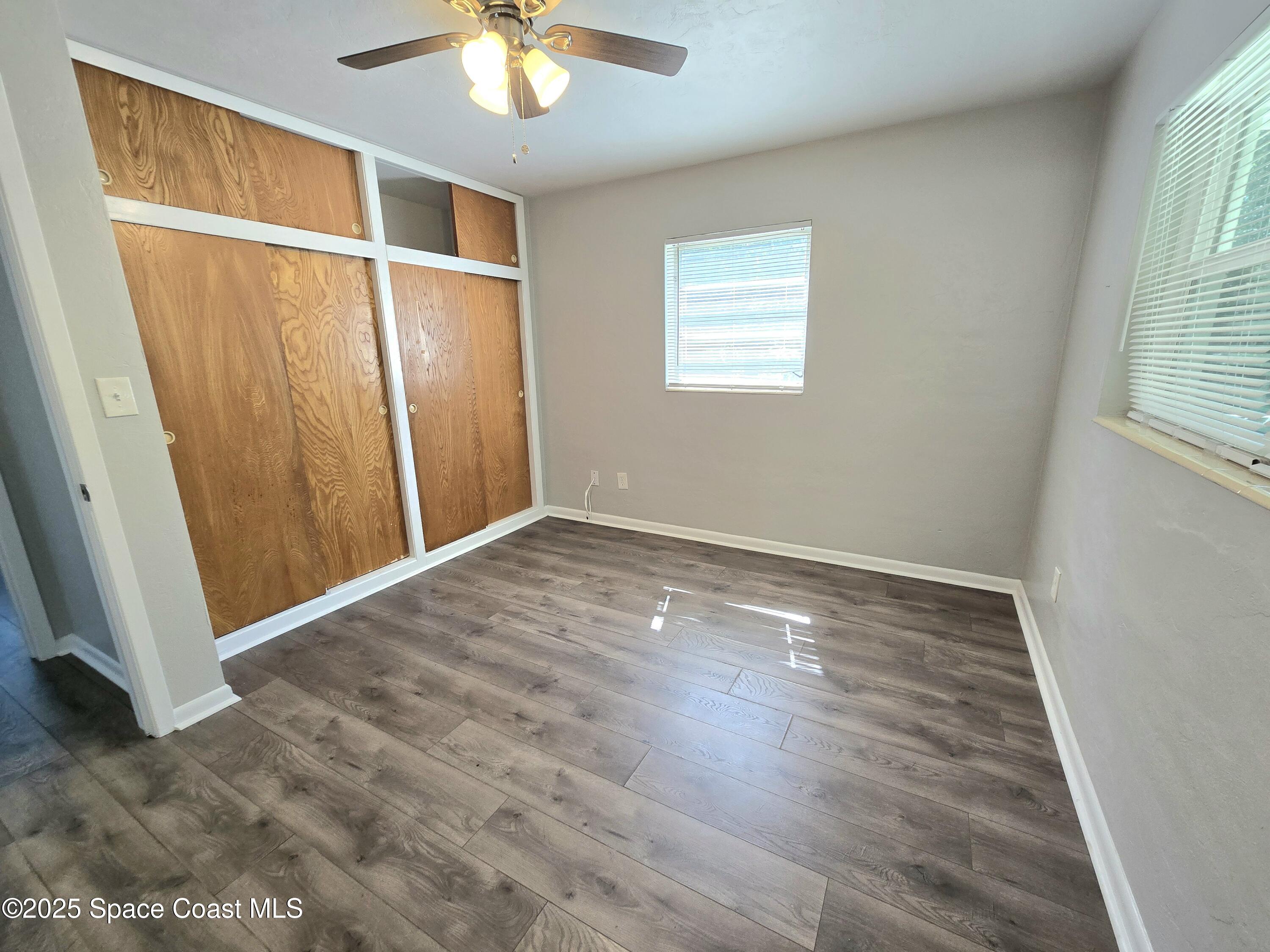 2373 Allan Adale Road Melbourne, FL 32935 - Photo 11 of 19 a view of an empty room with wooden floor and a window