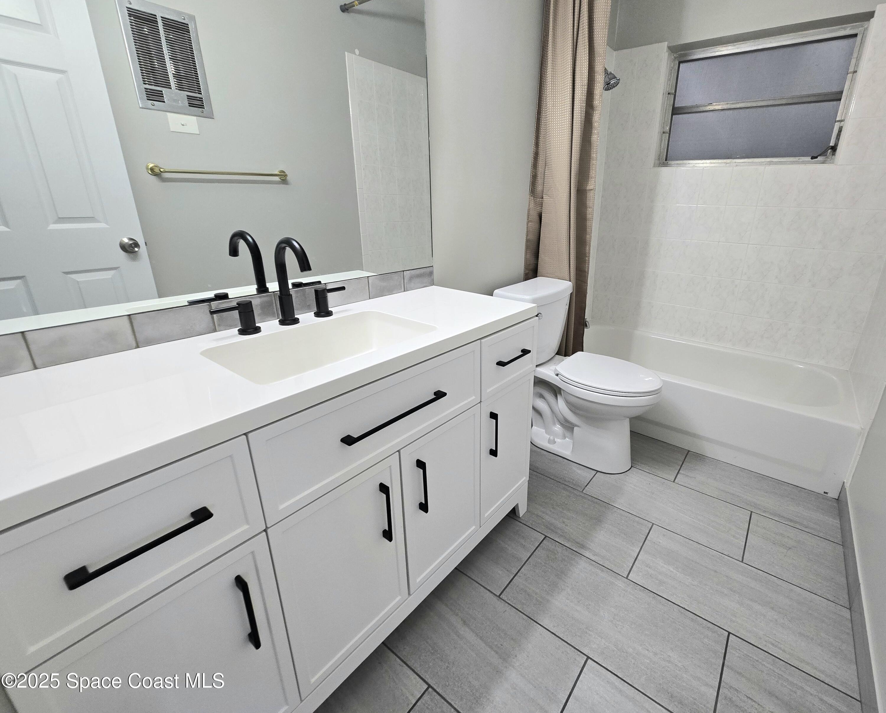 2373 Allan Adale Road Melbourne, FL 32935 - Photo 14 of 19 a bathroom with a sink and a toilet