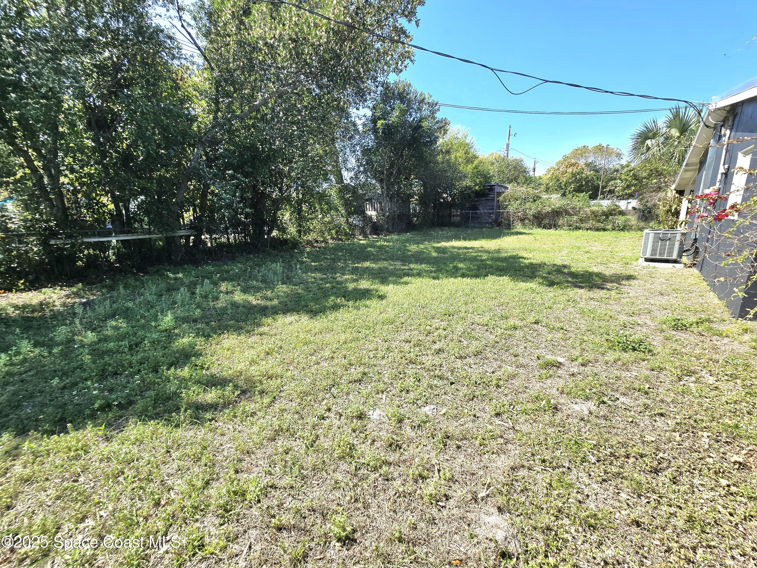 2373 Allan Adale Road Melbourne, FL 32935 - Photo 19 of 19 a view of a garden with a bench