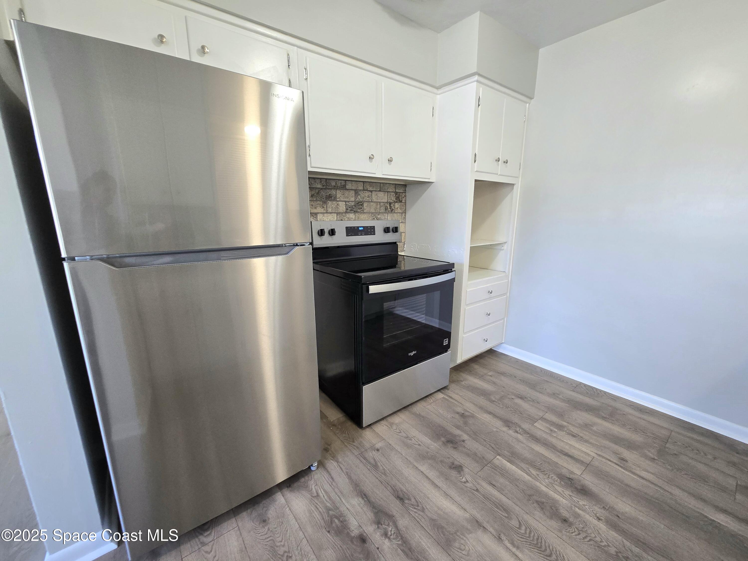 2373 Allan Adale Road Melbourne, FL 32935 - Photo 7 of 19 a kitchen with a refrigerator and a stove