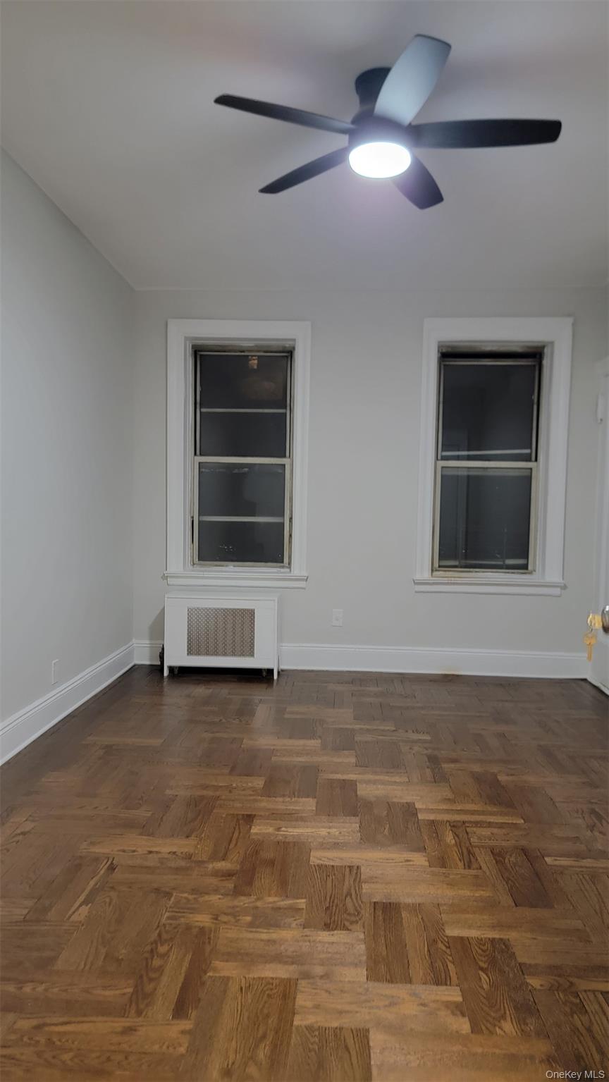 34-58 90th Street, Unit R5 Queens, NY 11372 - Photo 5 of 14 Unfurnished room with radiator and a ceiling fan