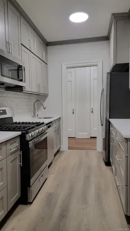 a kitchen with stainless steel appliances a refrigerator sink and cabinets