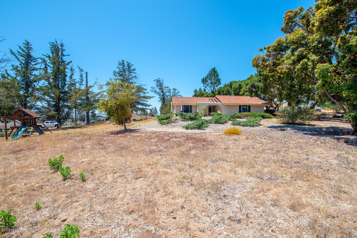 1386 Onstott Road Lompoc, CA 93436 - Photo 1 of 35 a row of palm trees in front of a house