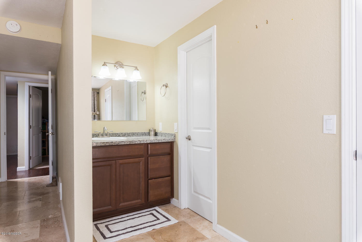 1386 Onstott Road Lompoc, CA 93436 - Photo 17 of 35 a bathroom with a granite countertop sink and a mirror