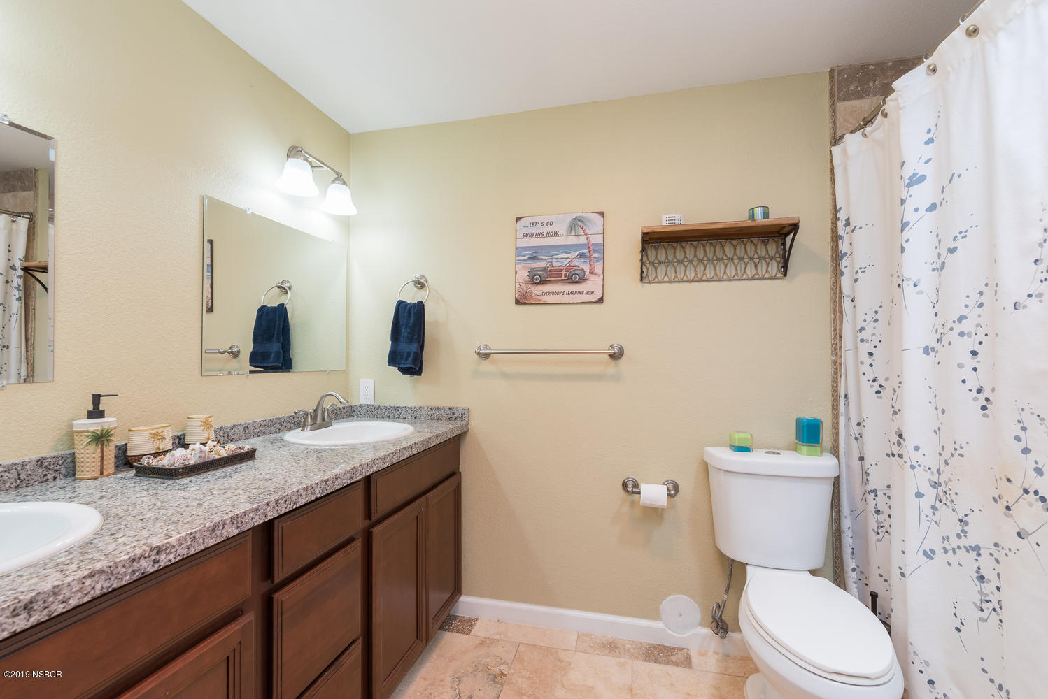 1386 Onstott Road Lompoc, CA 93436 - Photo 21 of 35 a bathroom with a granite countertop toilet sink and mirror