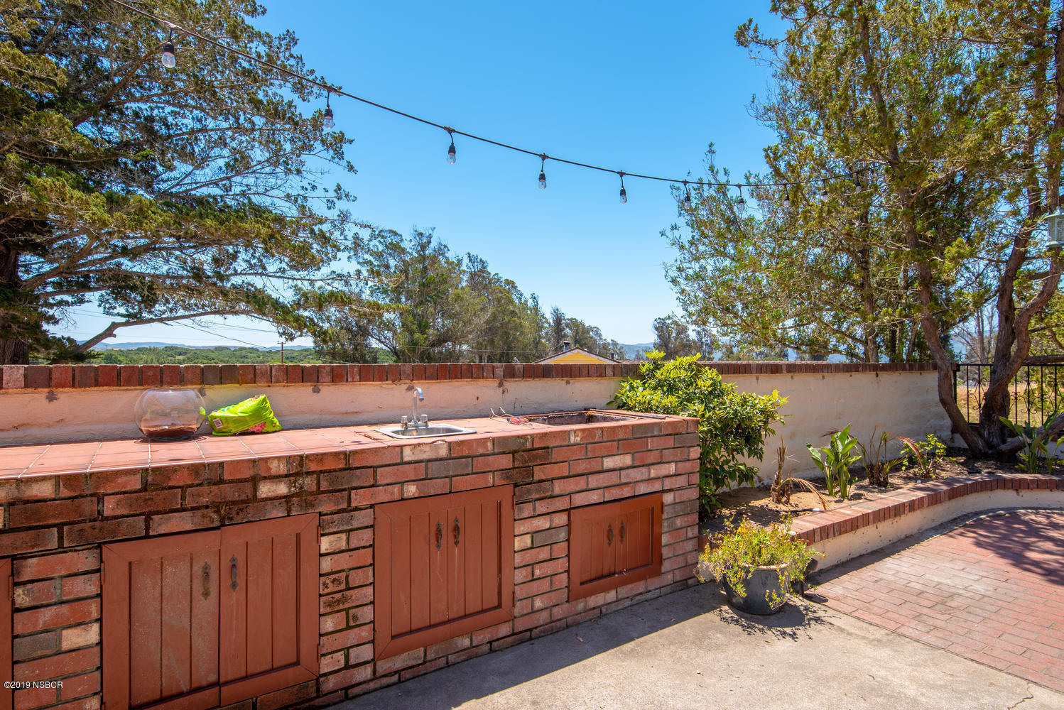 1386 Onstott Road Lompoc, CA 93436 - Photo 28 of 35 a view of a backyard with plants and a table