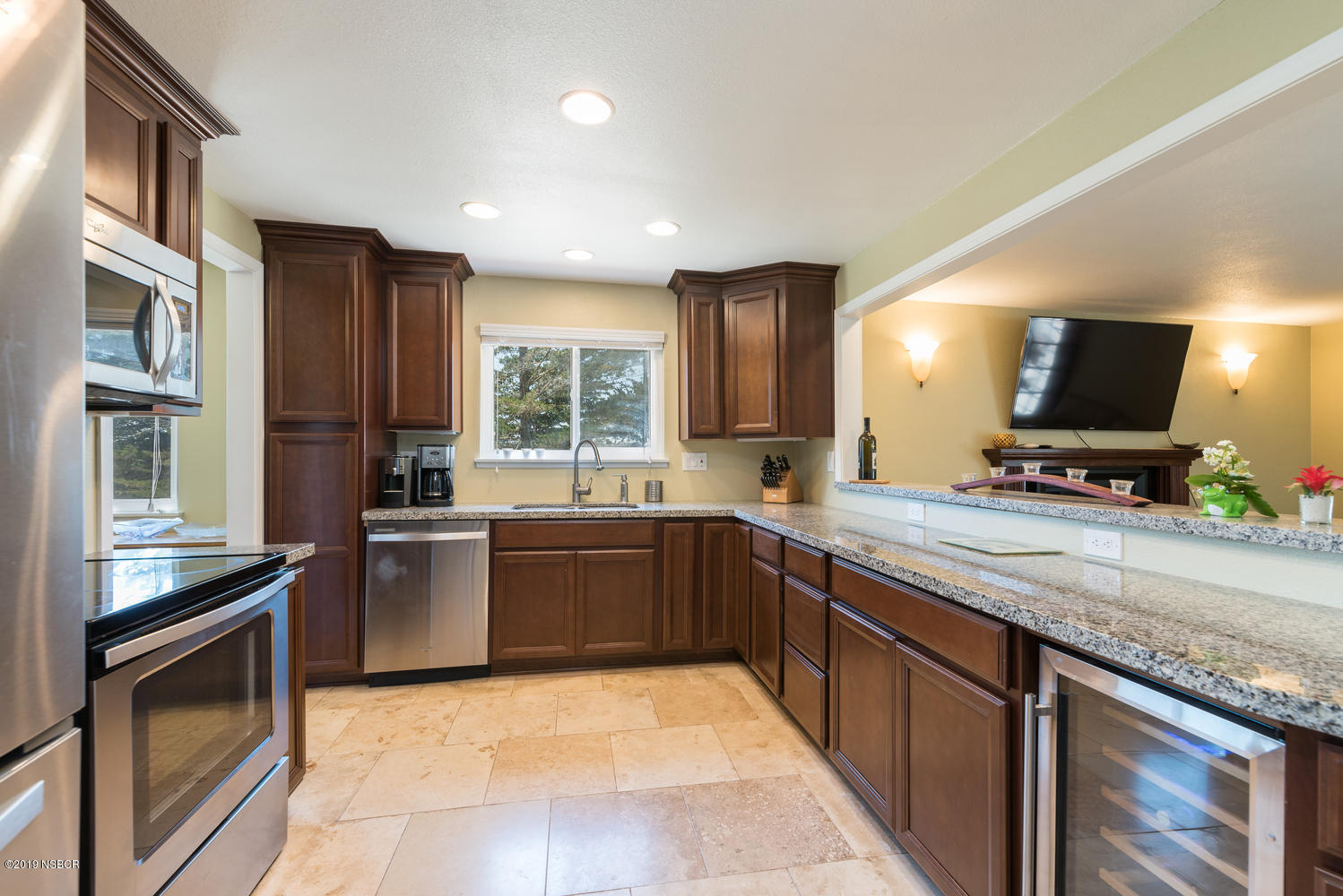 1386 Onstott Road Lompoc, CA 93436 - Photo 9 of 35 a kitchen with stainless steel appliances granite countertop a stove microwave and sink