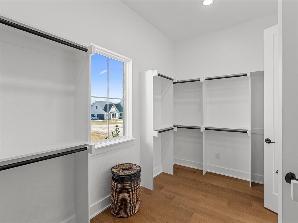 1301 Hunt Road Gunter, TX 75058 - Photo 26 of 40 a view of an empty room with wooden floor and a window