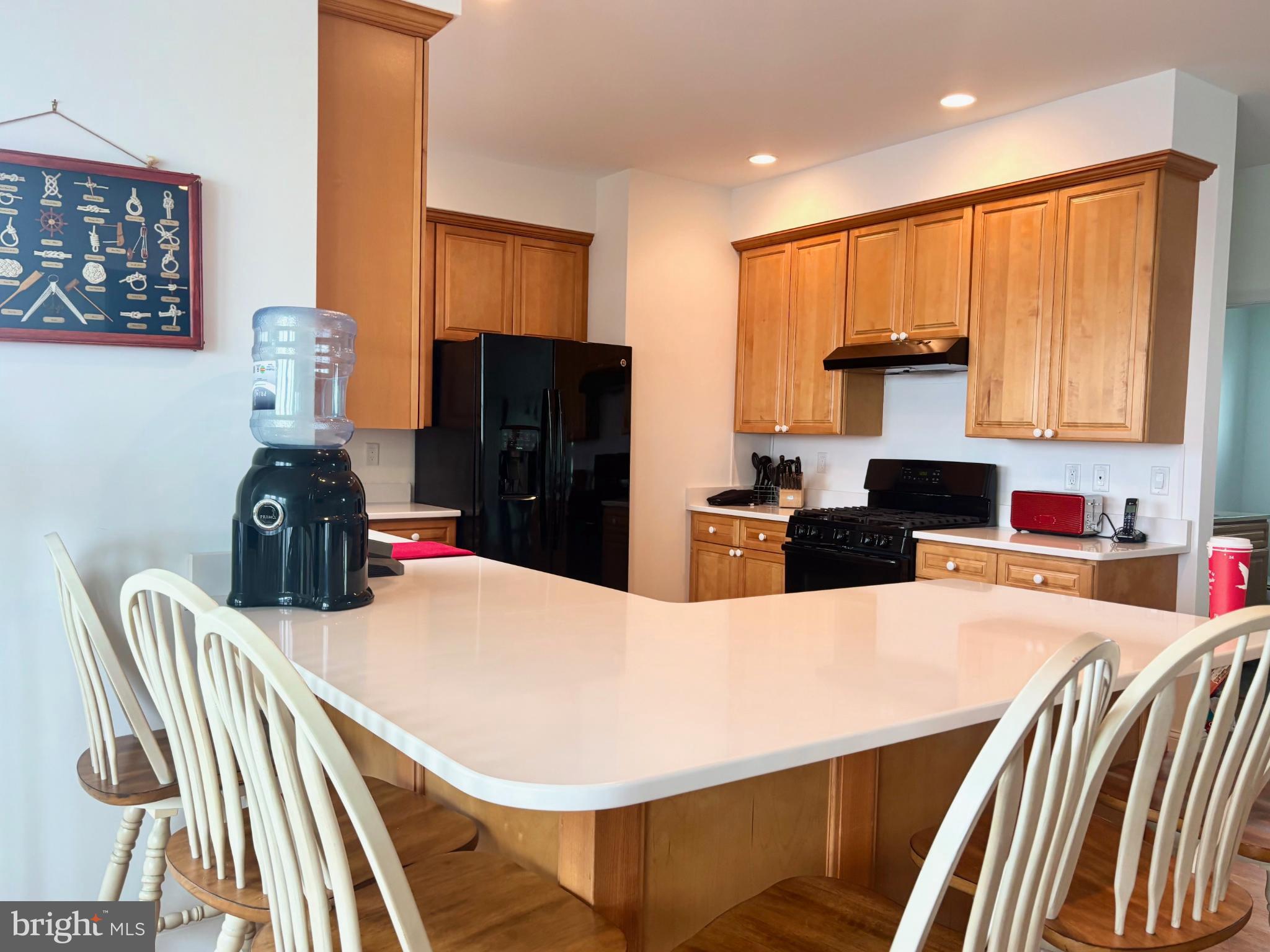 448 Dock Road West Creek, NJ 08092 - Photo 12 of 36 a kitchen with stainless steel appliances kitchen island granite countertop a refrigerator a stove a sink and dishwasher