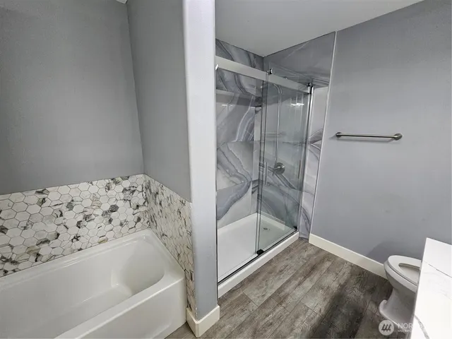 a bathroom with a bathtub and a shower