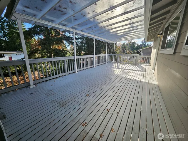 a view of a balcony with wooden floor
