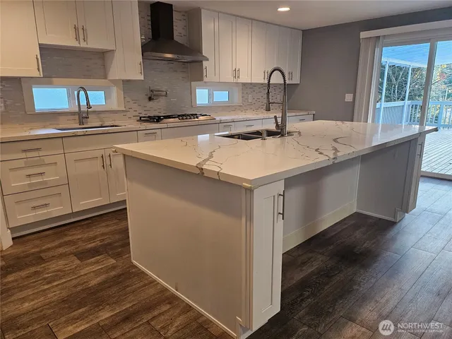 a kitchen with a sink cabinets and window