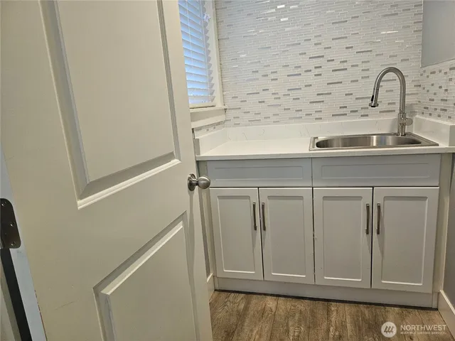 a close view of a sink and dishwasher in a bathroom