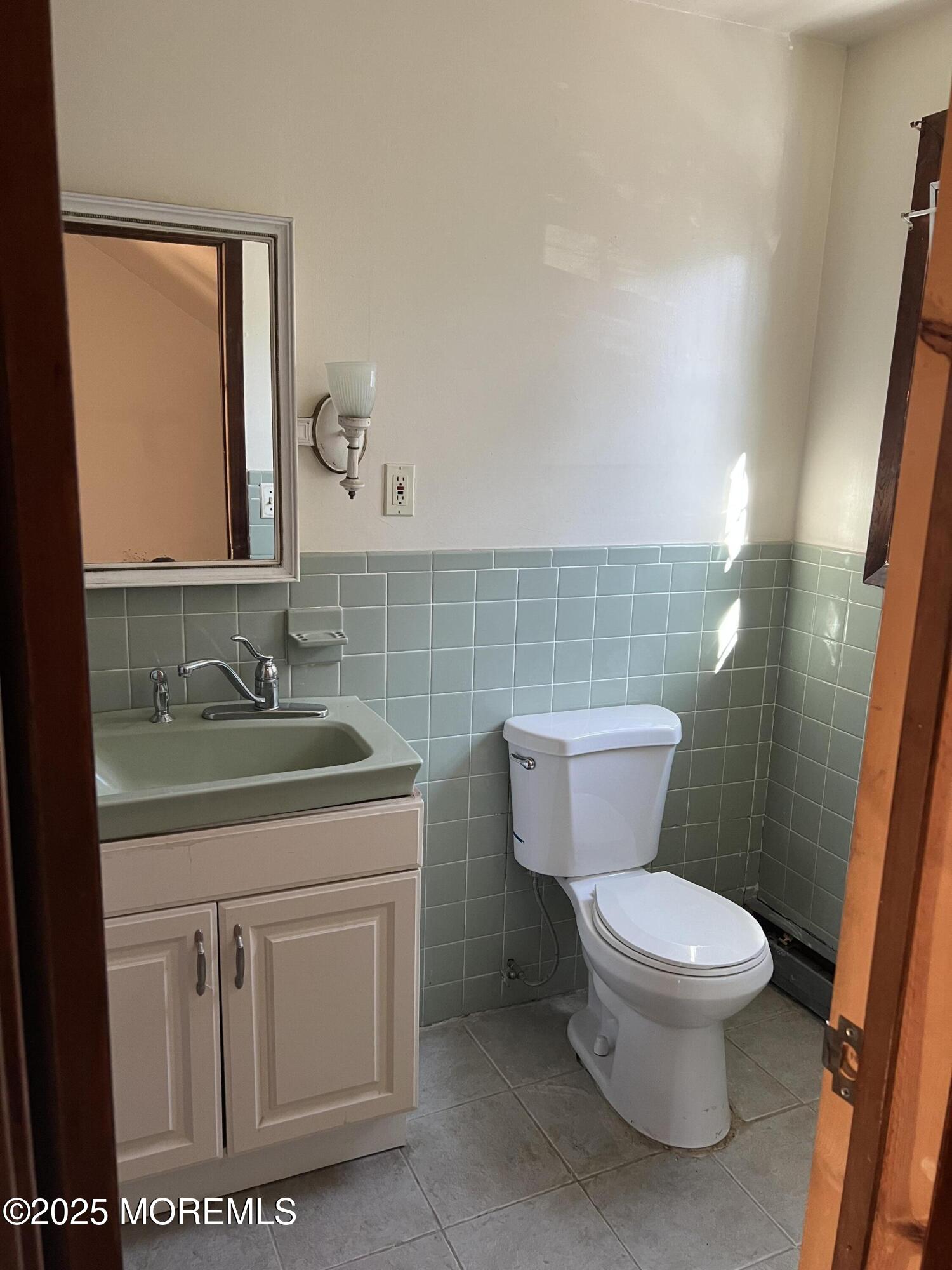 84 Bethany Road Hazlet, NJ 07730 - Photo 13 of 21 a bathroom with a toilet sink and mirror
