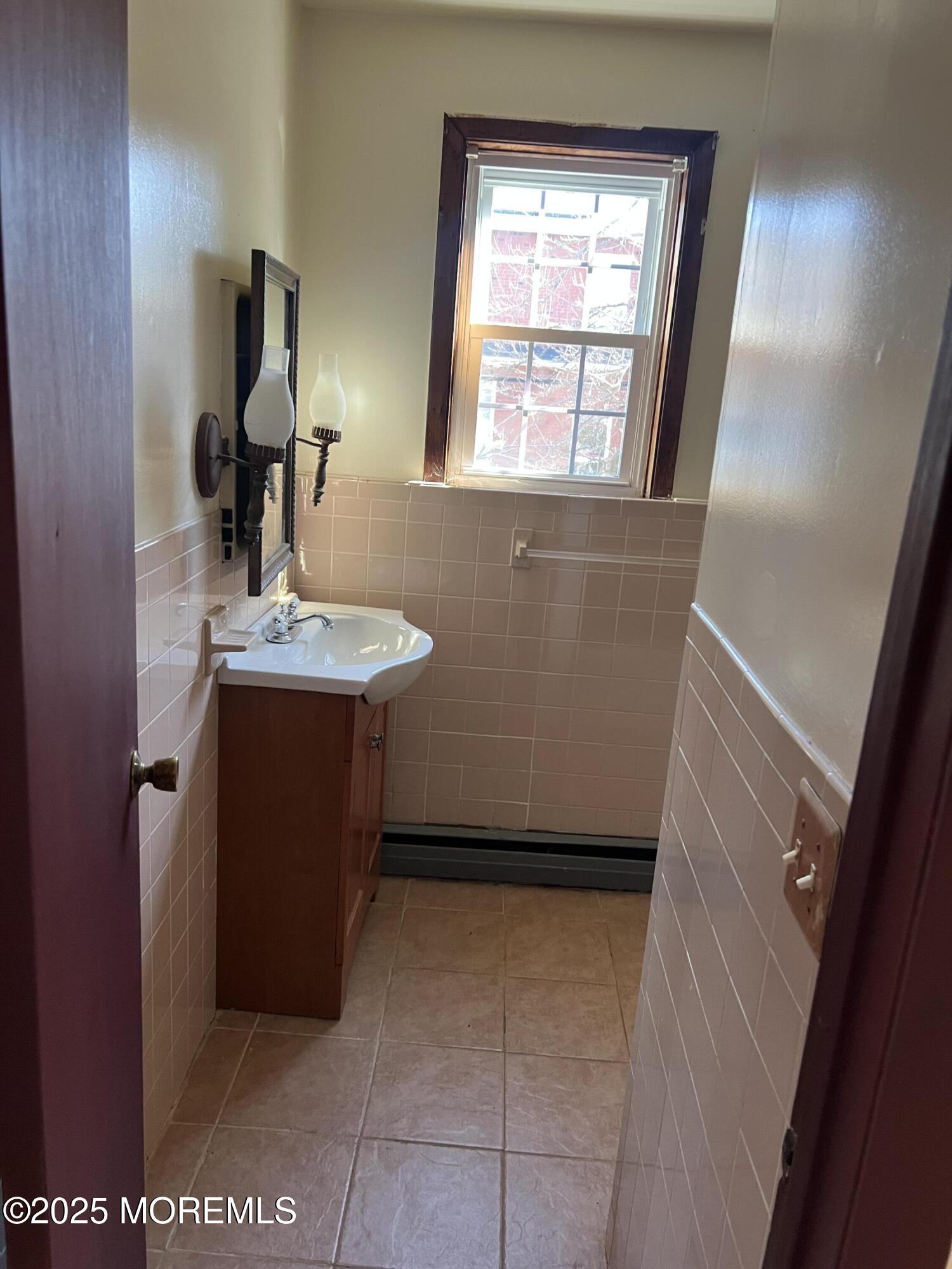 84 Bethany Road Hazlet, NJ 07730 - Photo 16 of 21 a bathroom with a sink a mirror and vanity