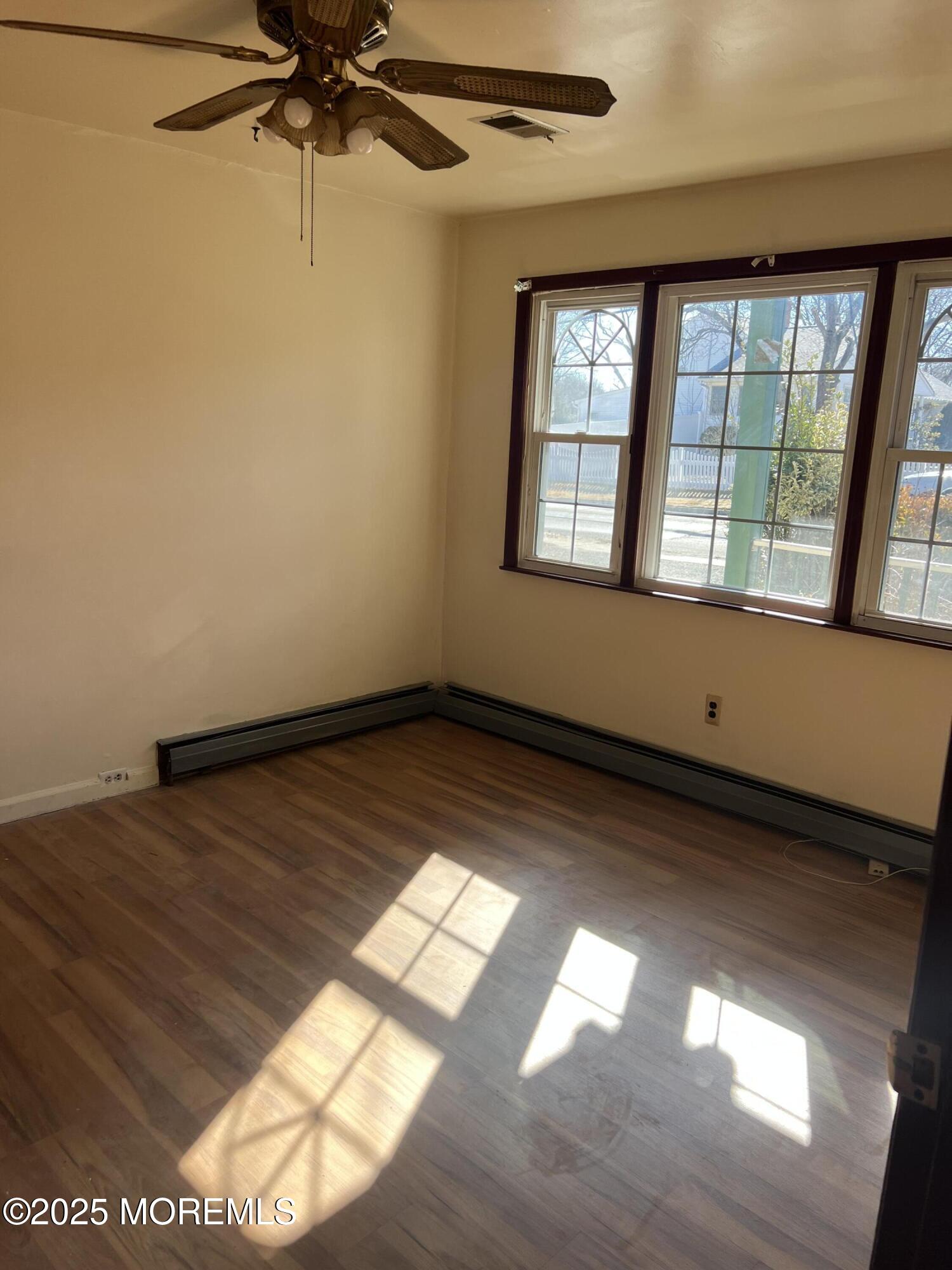84 Bethany Road Hazlet, NJ 07730 - Photo 17 of 21 wooden floor in an empty room with a window