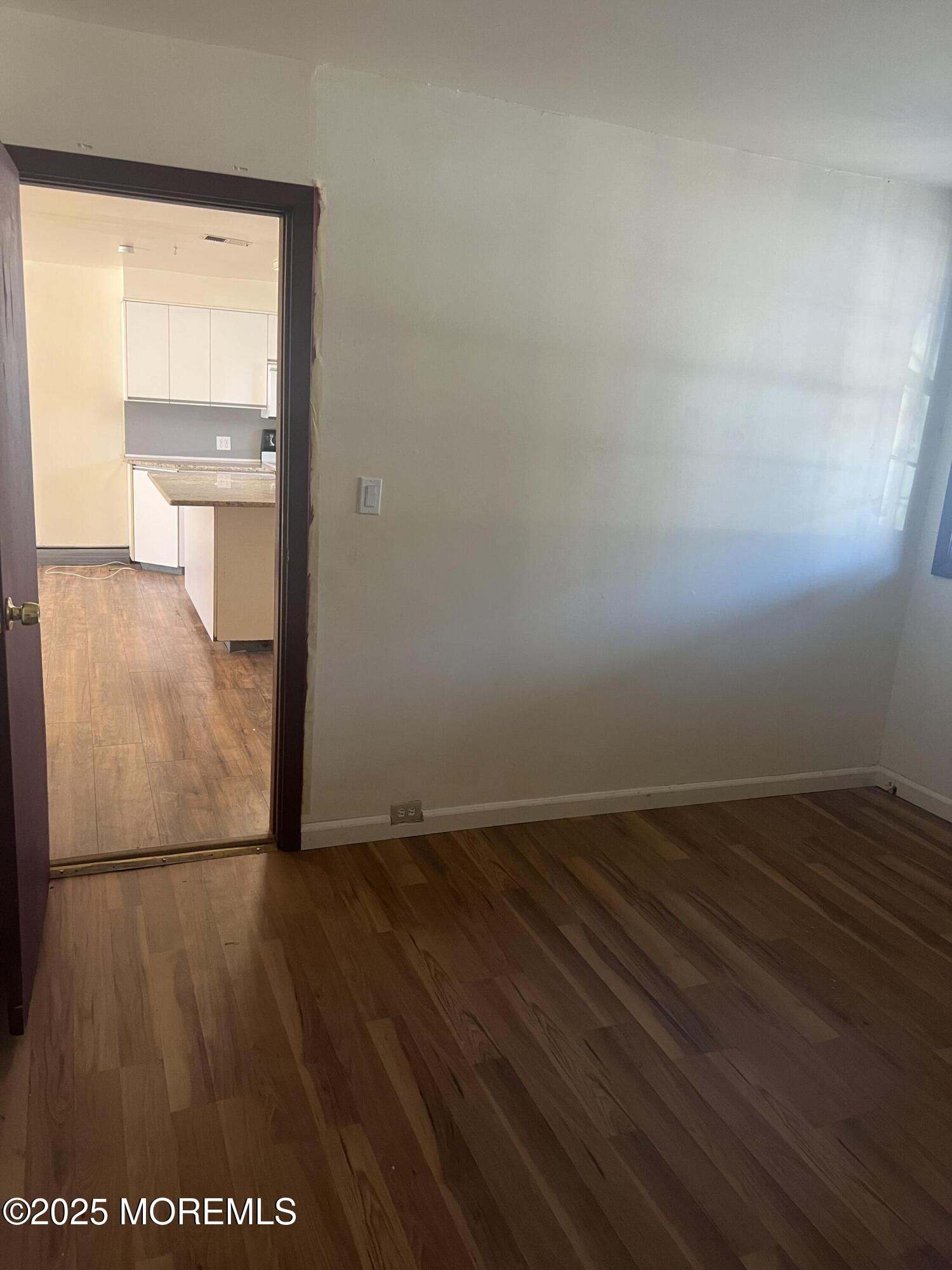 84 Bethany Road Hazlet, NJ 07730 - Photo 18 of 21 an empty room with wooden floor and windows