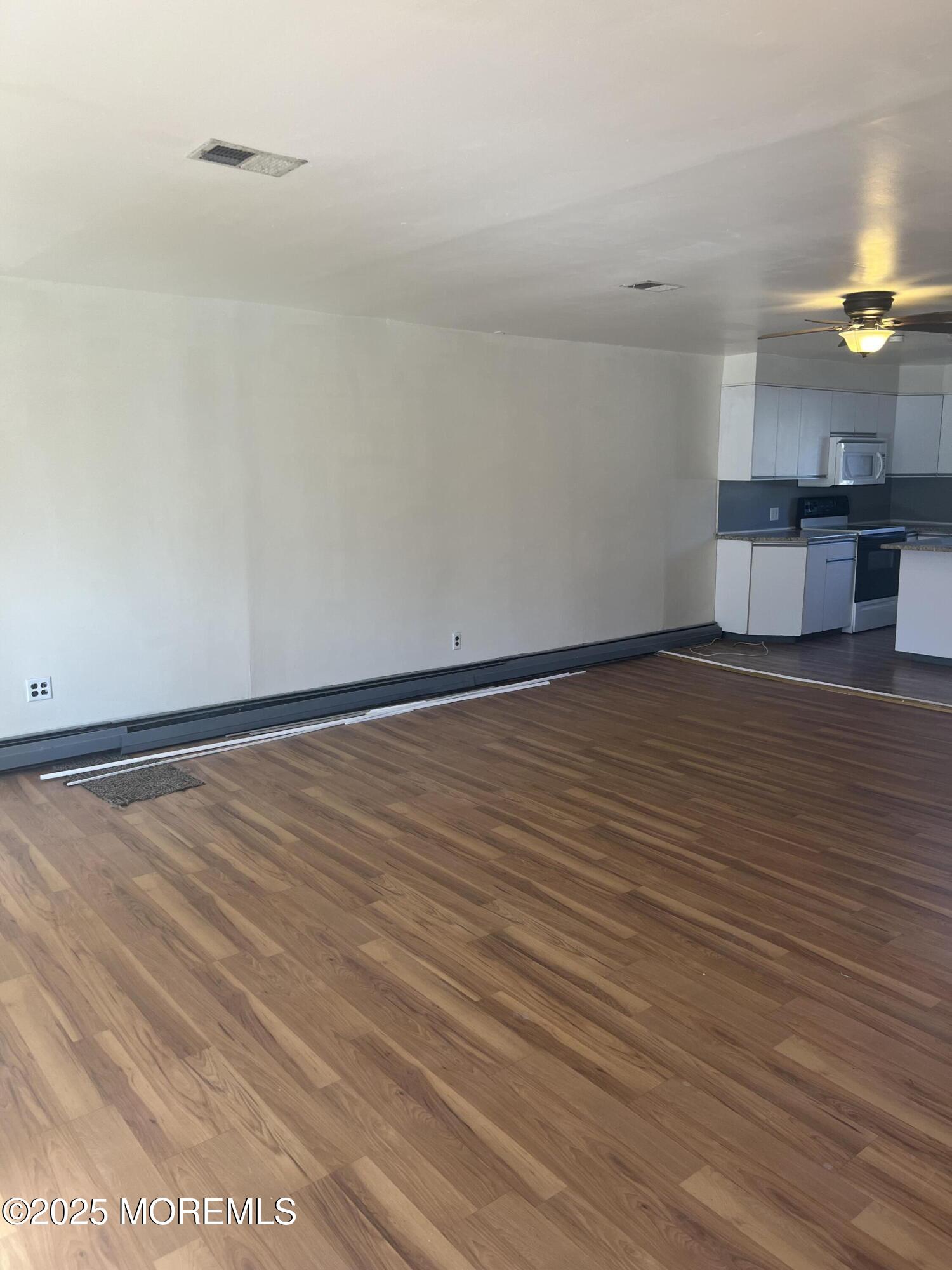 84 Bethany Road Hazlet, NJ 07730 - Photo 5 of 21 a view of an empty room with wooden floor