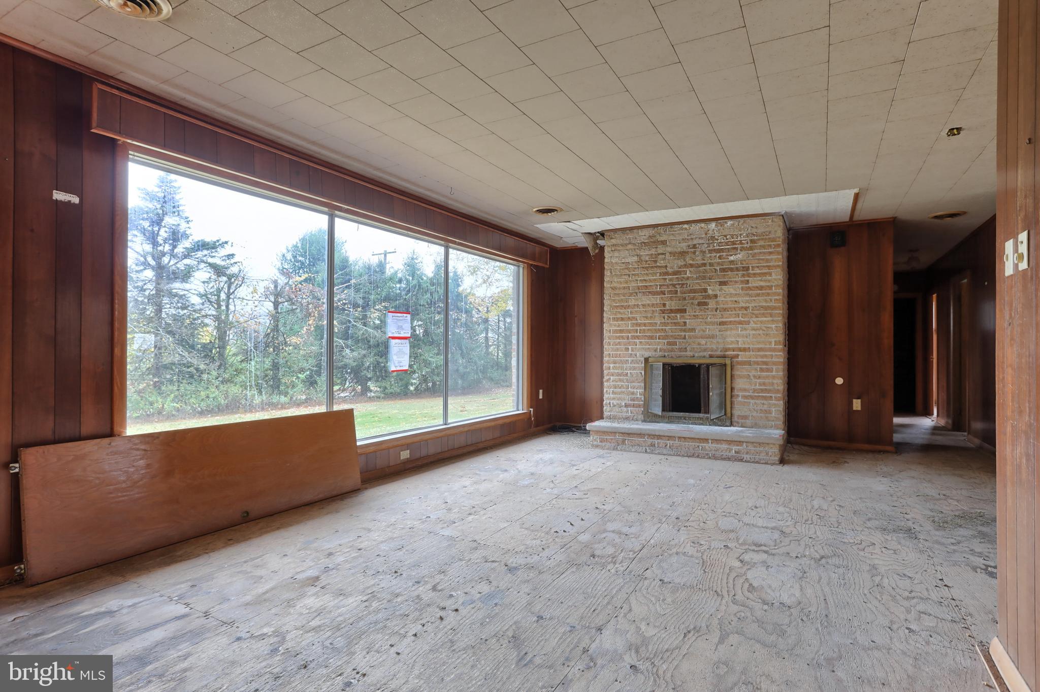 77 Tiley Road Ashland, PA 17921 - Photo 2 of 35 a view of an empty room with a fireplace and a large window