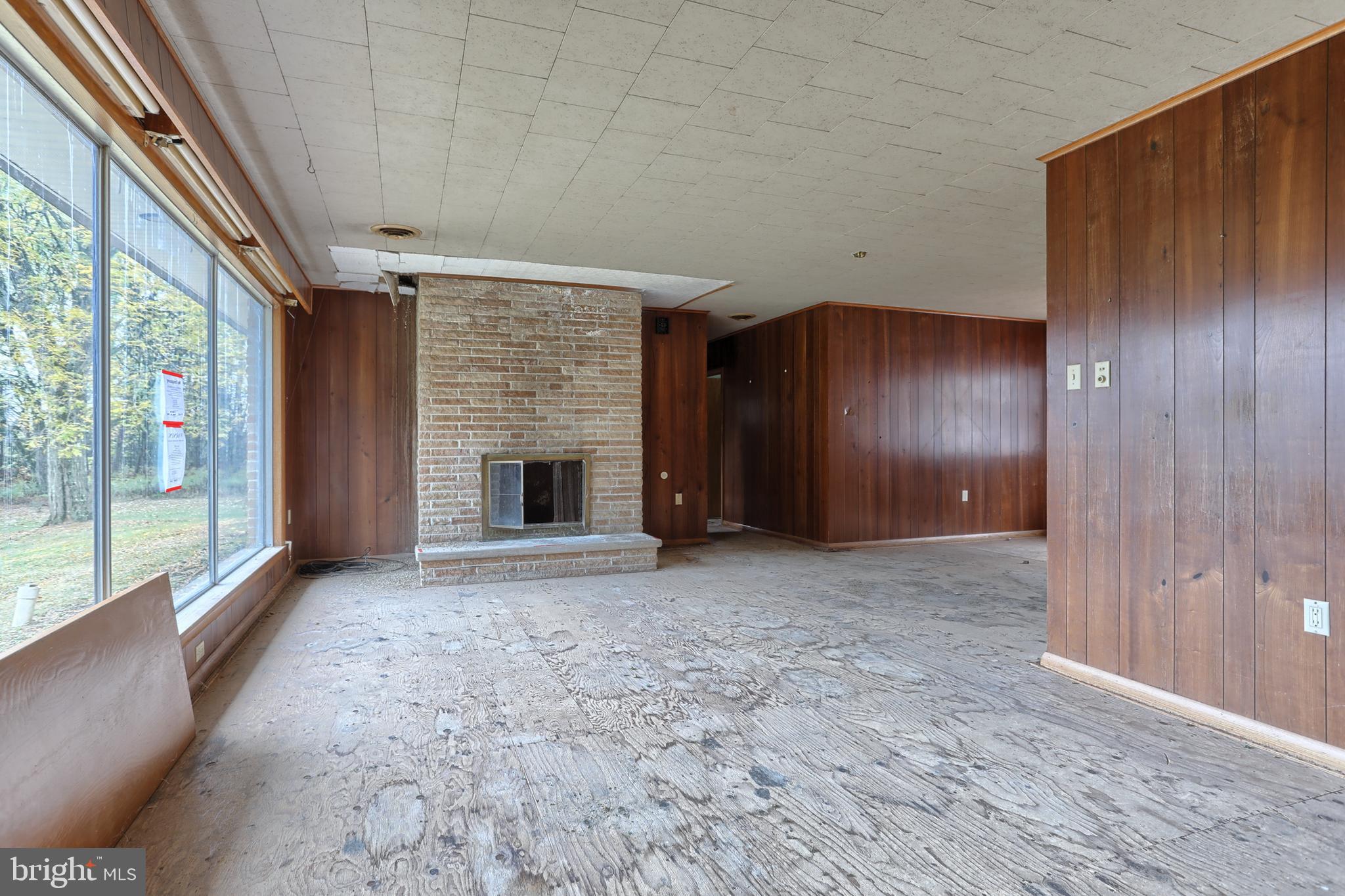77 Tiley Road Ashland, PA 17921 - Photo 5 of 35 a view of an empty room with a fireplace and a window