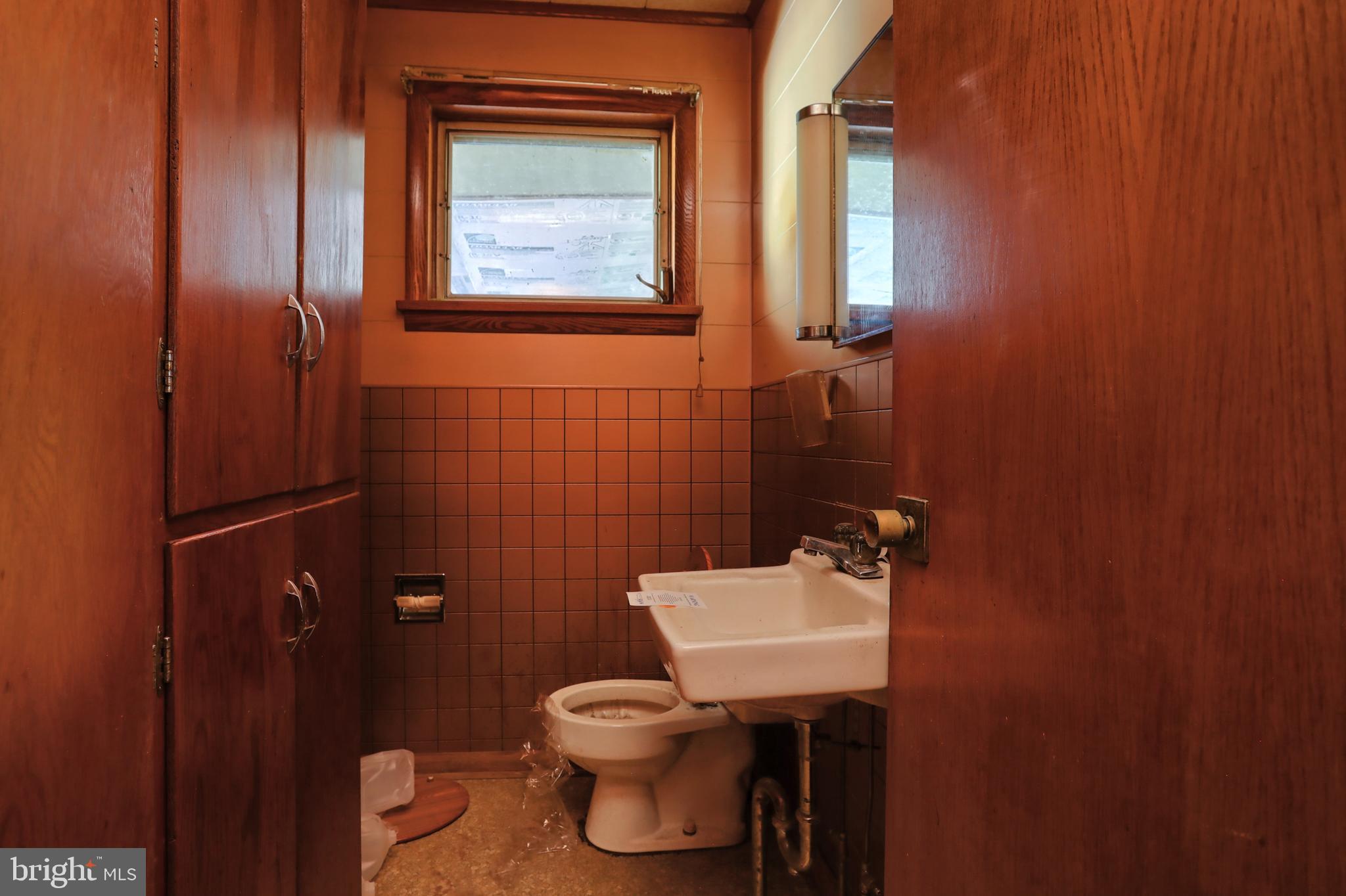 77 Tiley Road Ashland, PA 17921 - Photo 10 of 35 a bathroom with a toilet a sink and mirror