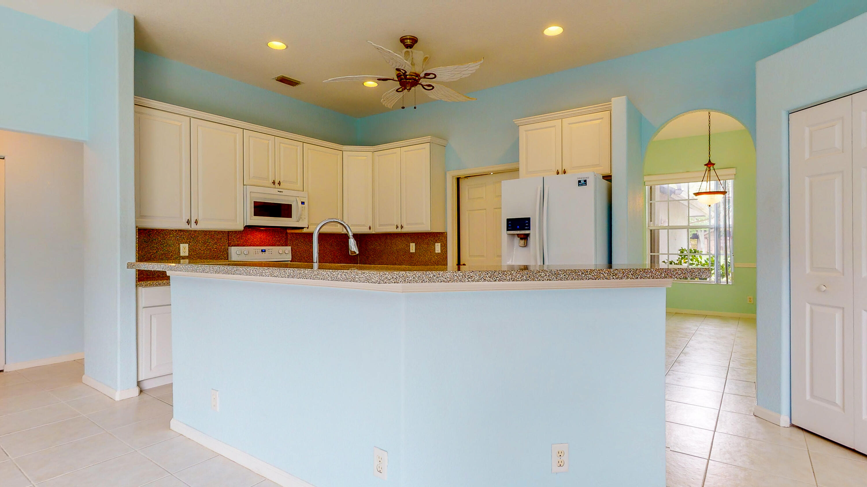 2072 Southeast Hanford Road Port St. Lucie, FL 34952 - Photo 17 of 48 a kitchen with stainless steel appliances a refrigerator sink and cabinets