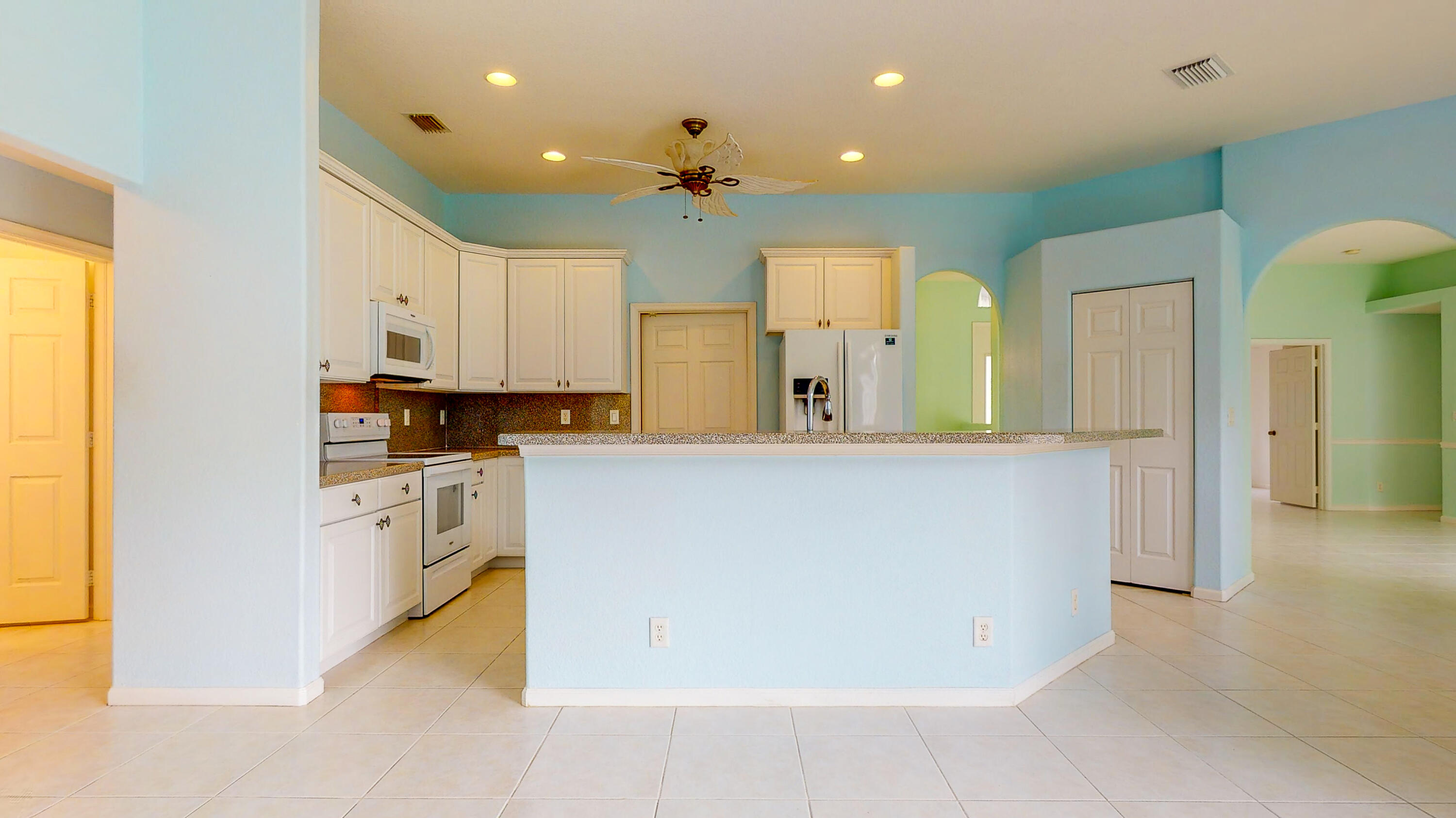 2072 Southeast Hanford Road Port St. Lucie, FL 34952 - Photo 18 of 48 a large kitchen with cabinets and a refrigerator