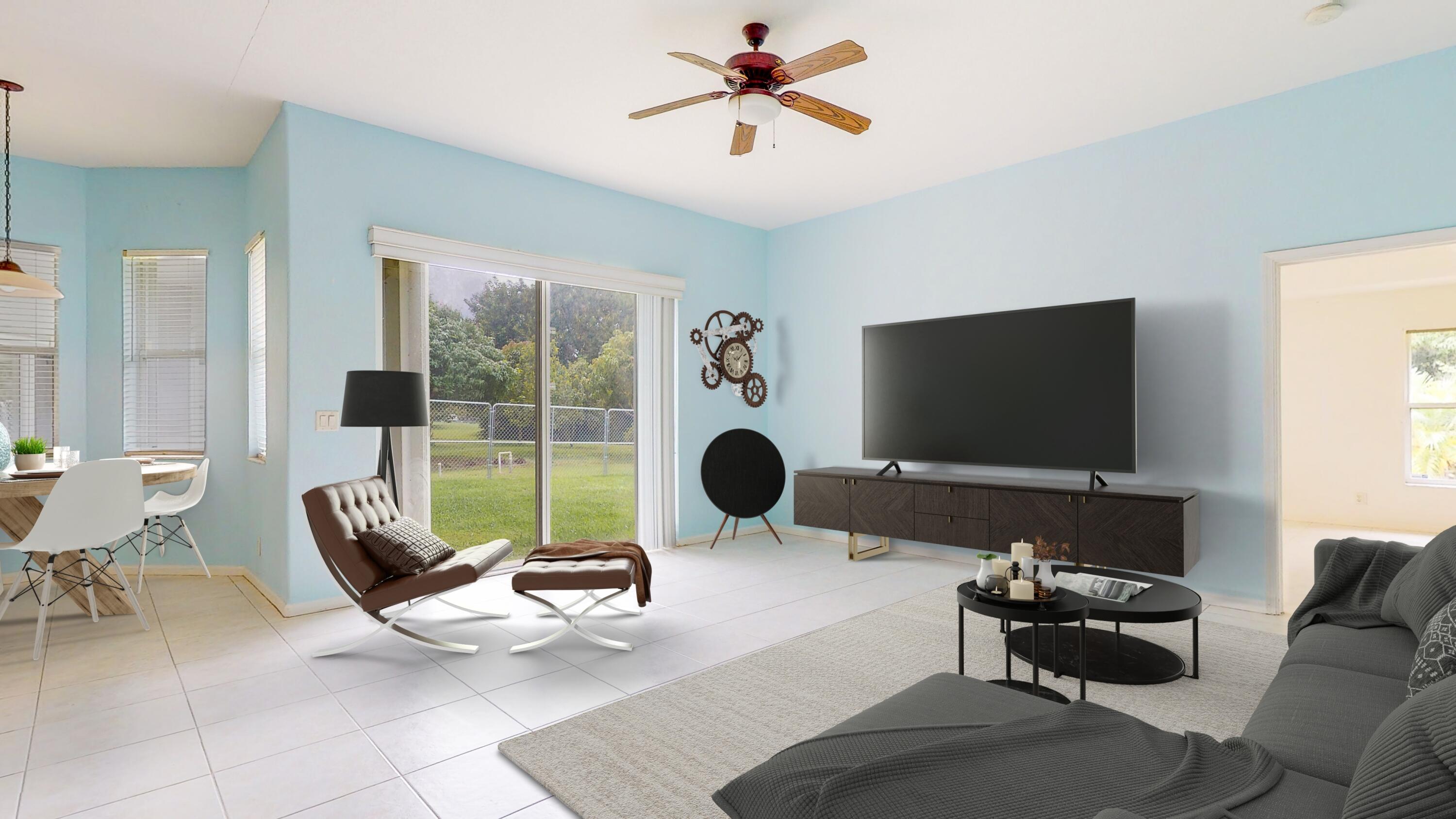 2072 Southeast Hanford Road Port St. Lucie, FL 34952 - Photo 19 of 48 a living room with furniture a flat screen tv and a large window