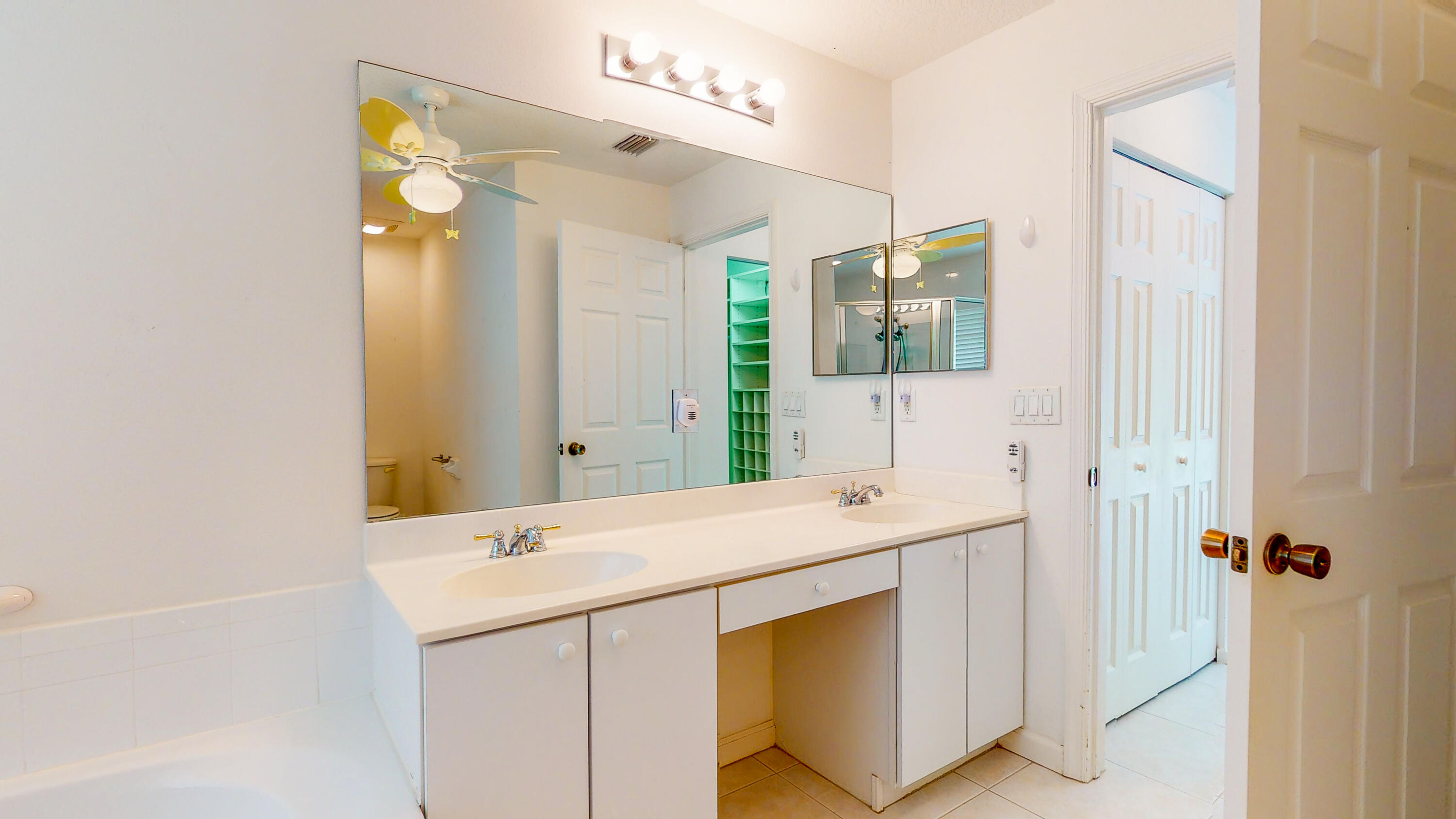 2072 Southeast Hanford Road Port St. Lucie, FL 34952 - Photo 23 of 48 a bathroom with a sink and a mirror