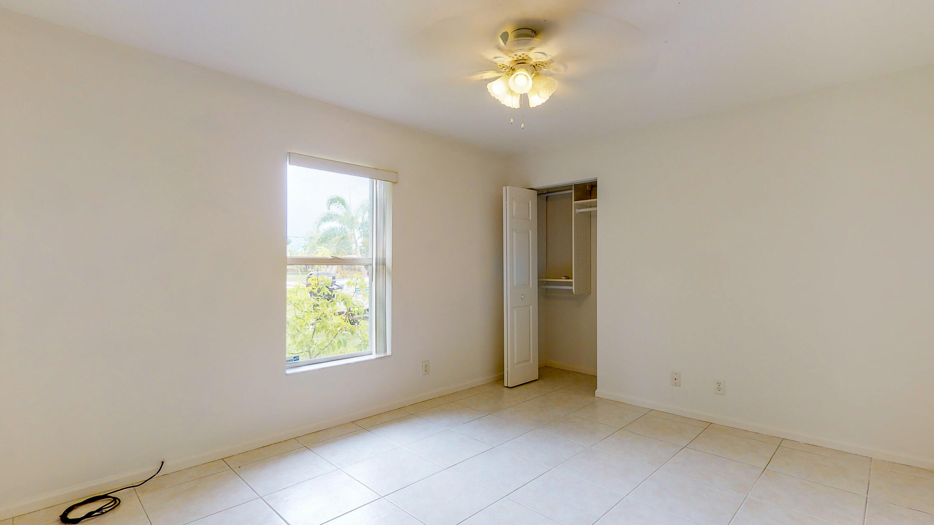 2072 Southeast Hanford Road Port St. Lucie, FL 34952 - Photo 30 of 48 an empty room with windows and chandelier fan