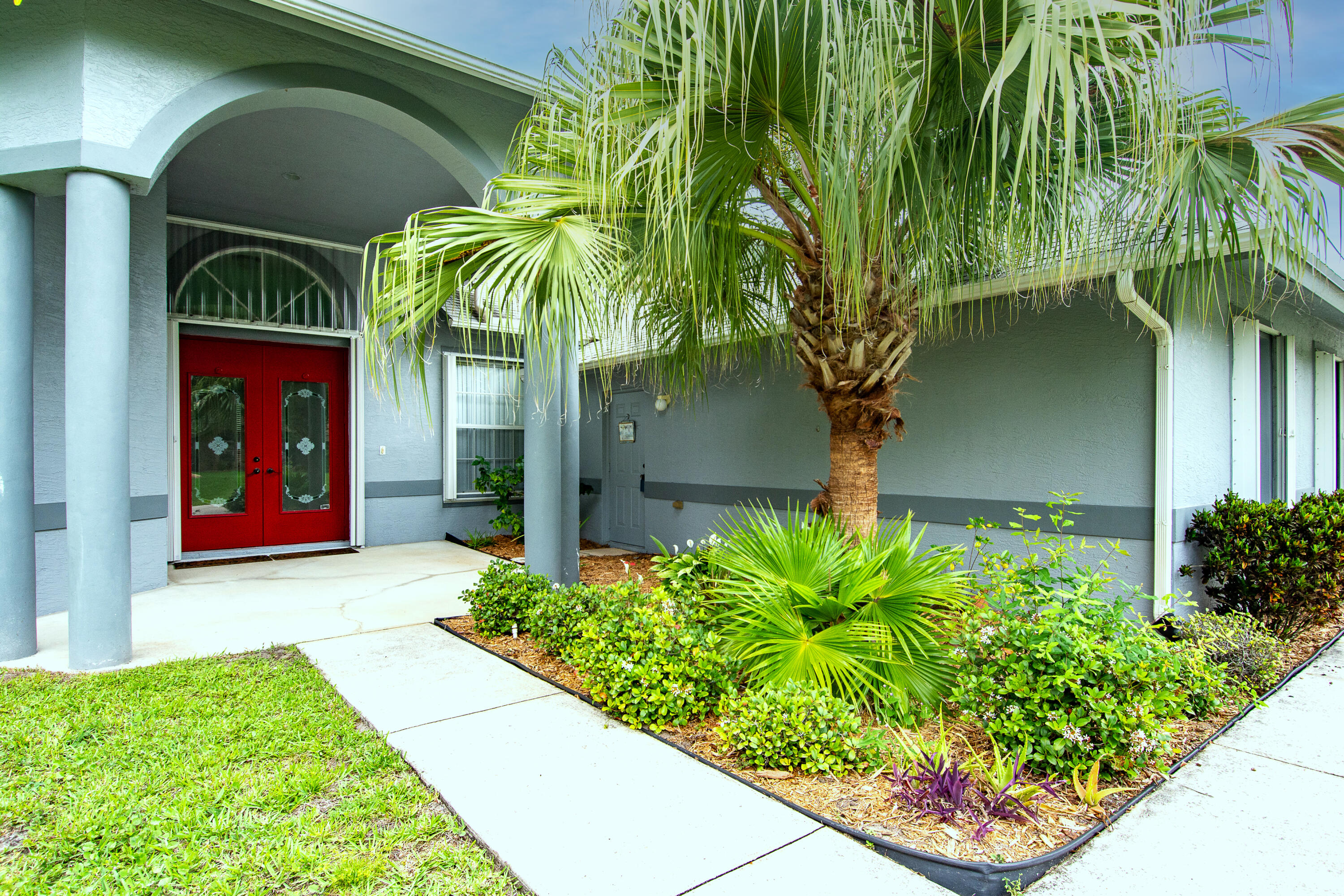 2072 Southeast Hanford Road Port St. Lucie, FL 34952 - Photo 3 of 48 a front view of a house with a yard