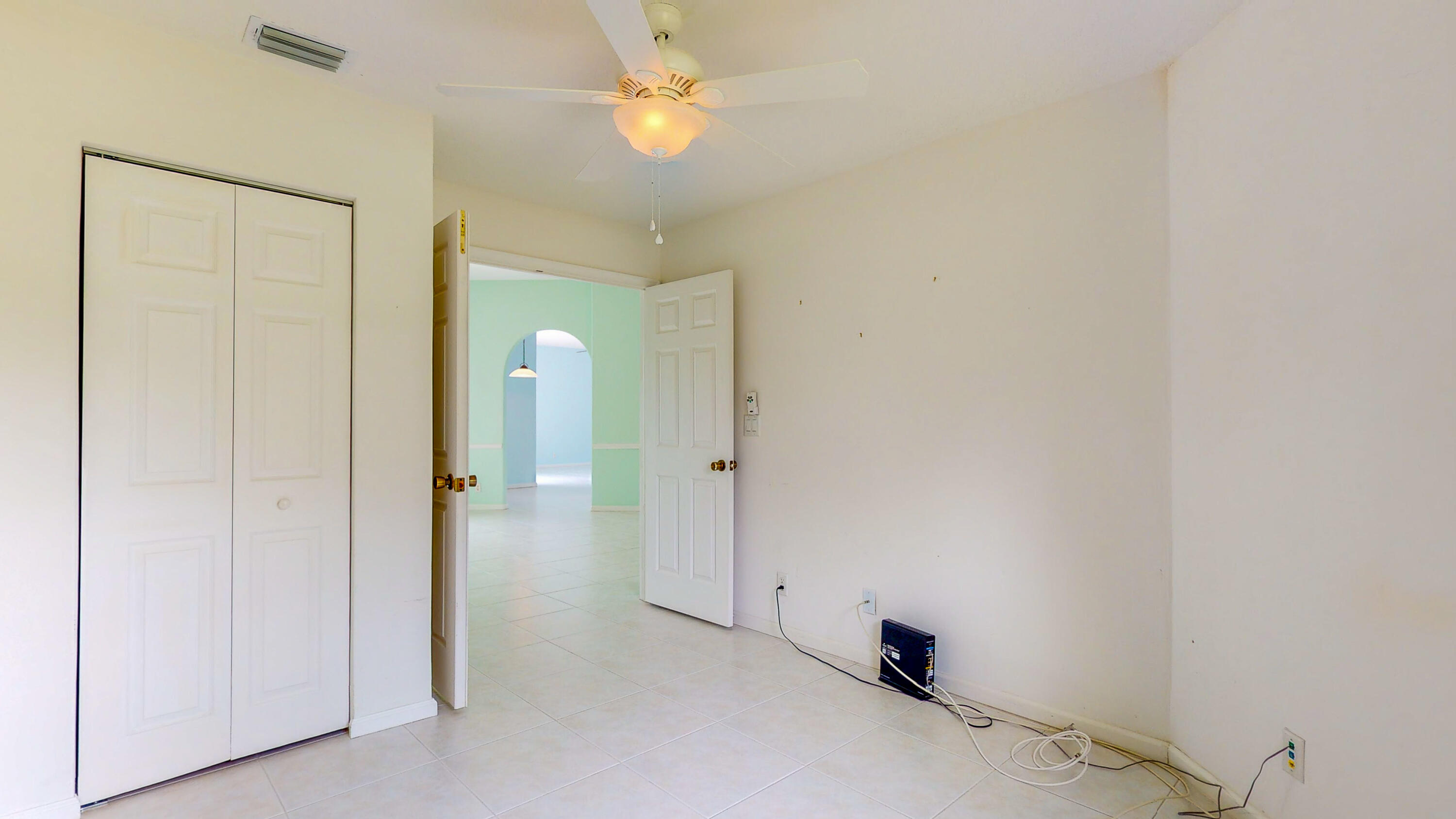 2072 Southeast Hanford Road Port St. Lucie, FL 34952 - Photo 32 of 48 a view of a room with a stylish ceiling fan and entryway