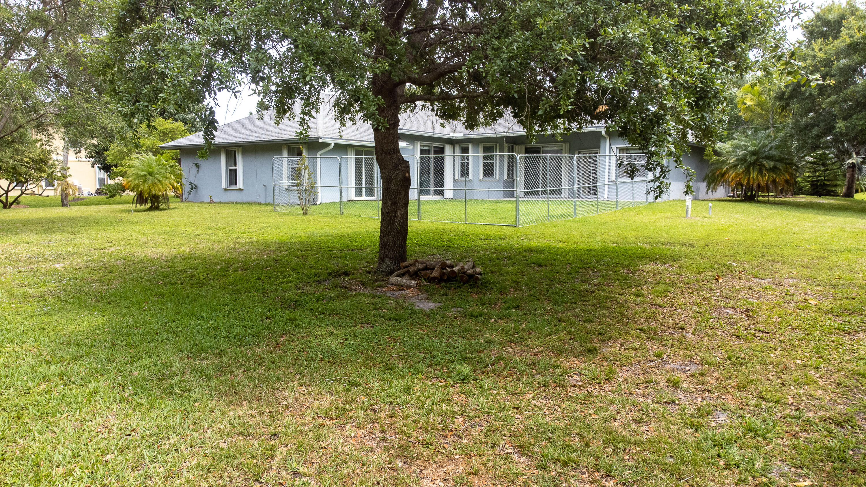 2072 Southeast Hanford Road Port St. Lucie, FL 34952 - Photo 36 of 48 a view of a house with a yard