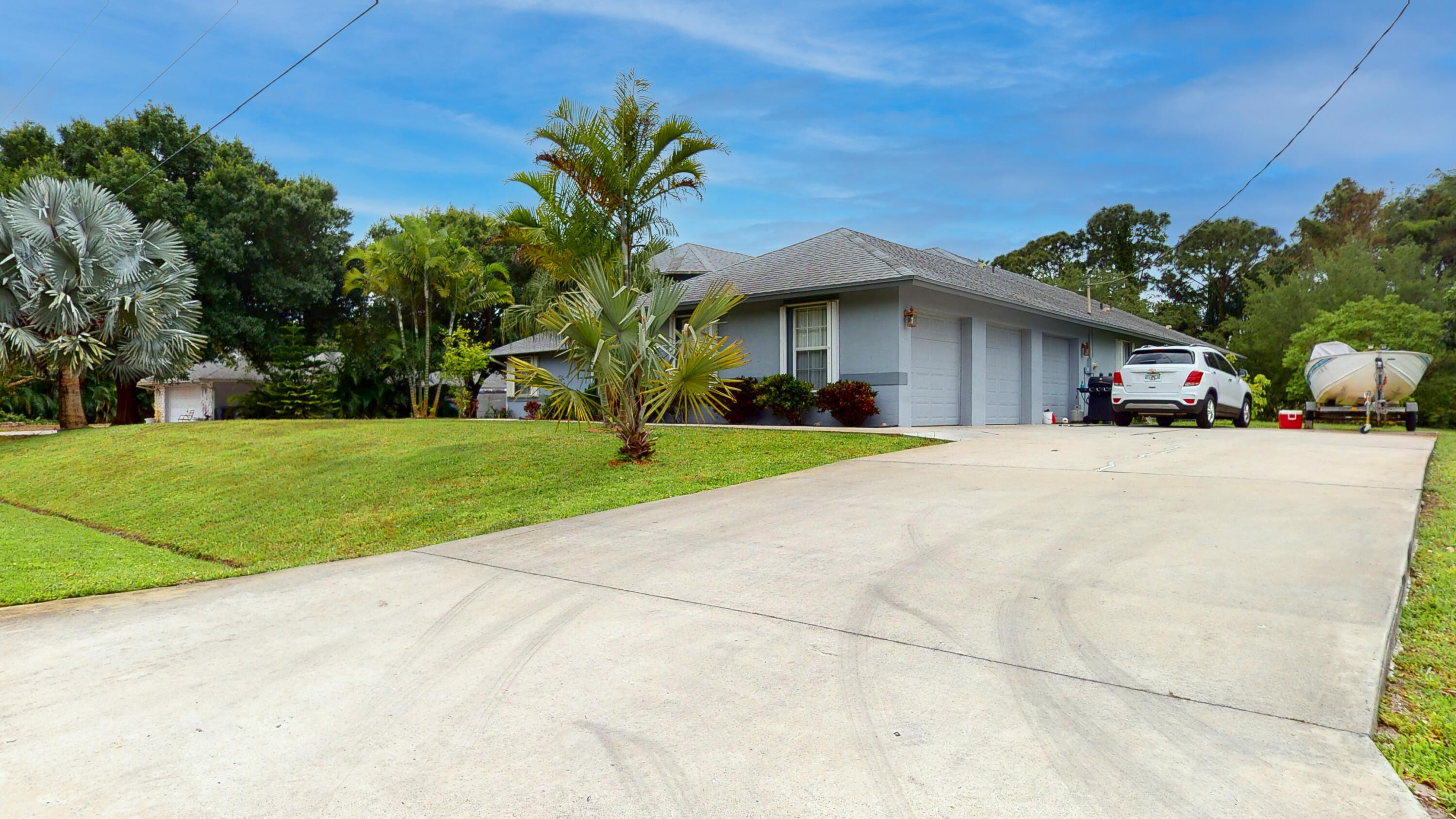 2072 Southeast Hanford Road Port St. Lucie, FL 34952 - Photo 38 of 48 a view of a house with a yard and potted plants