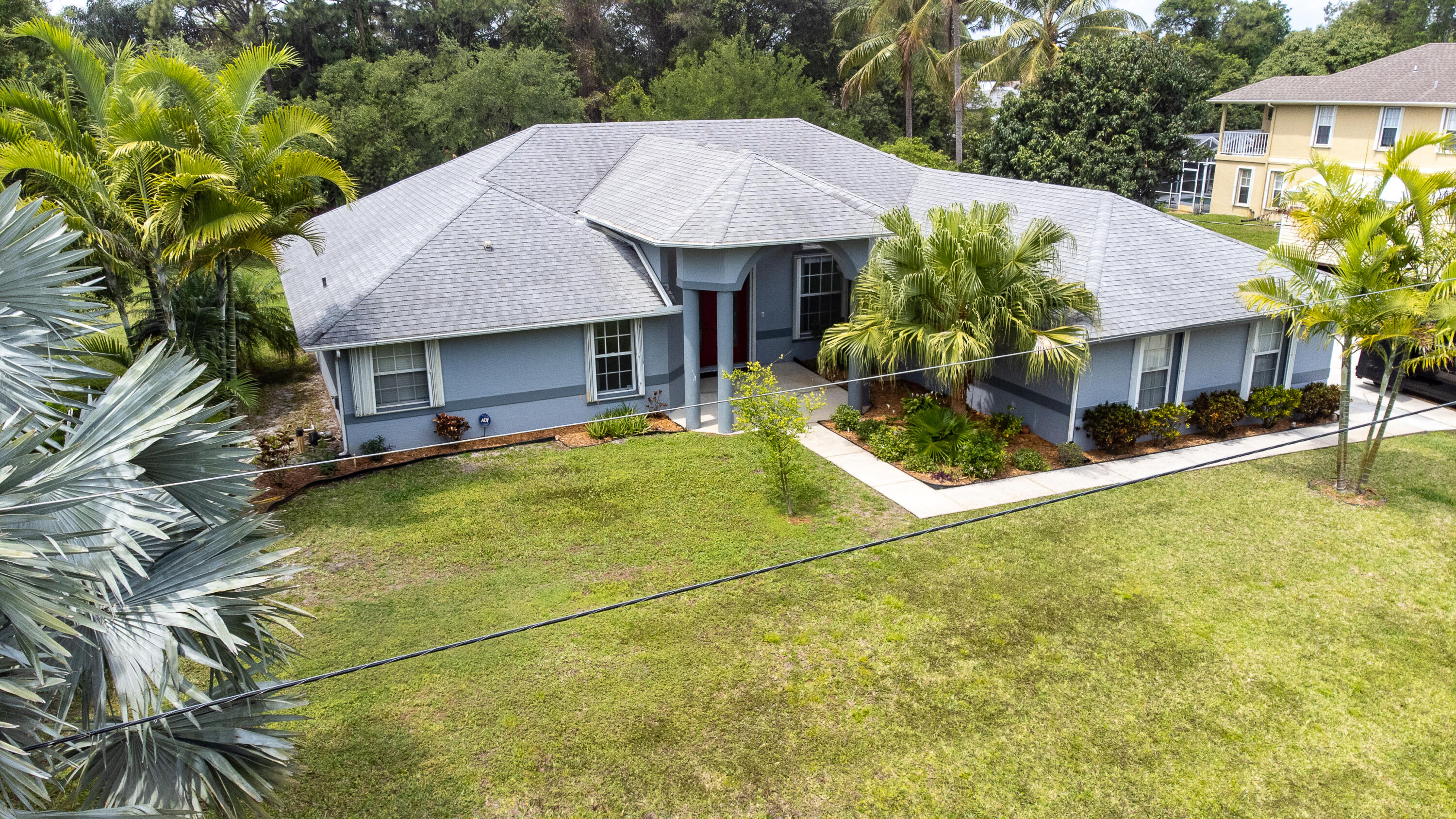 2072 Southeast Hanford Road Port St. Lucie, FL 34952 - Photo 47 of 48 a front view of a house with garden