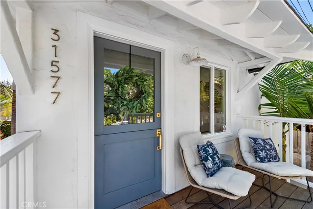 a outdoor living room with furniture and a potted plant