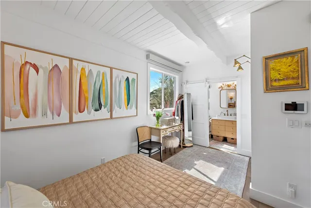 a bedroom with a bed a table and chair