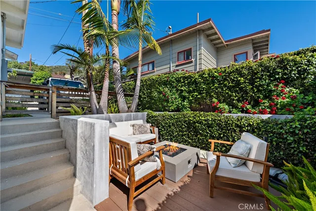 a view of a patio with couches table and chairs and potted plants