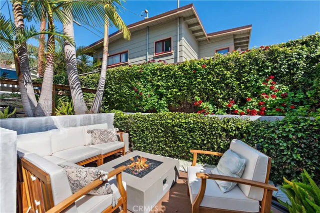 a view of backyard with outdoor seating and green space
