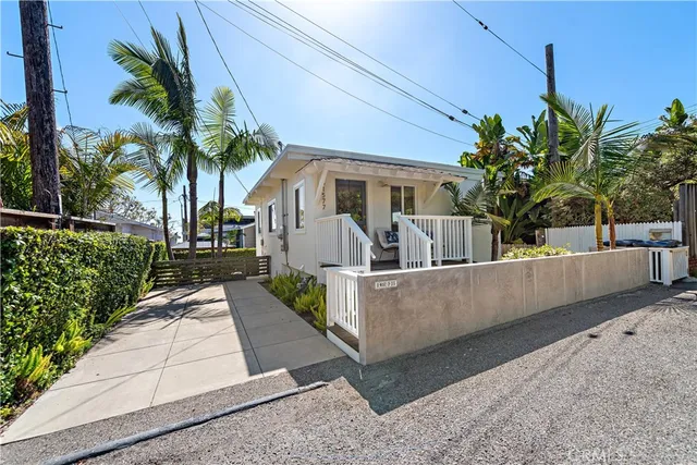 a view of house with palm tree in the background