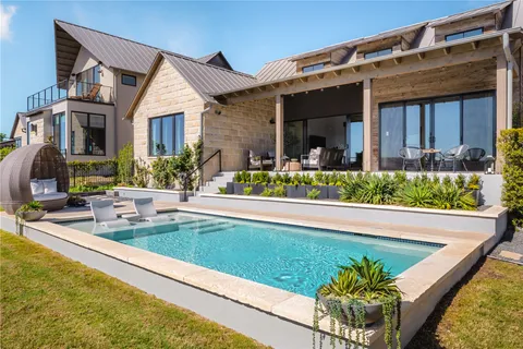 a front view of house and swimming pool with patio