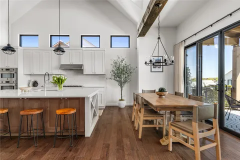 a kitchen with a table chairs refrigerator and microwave